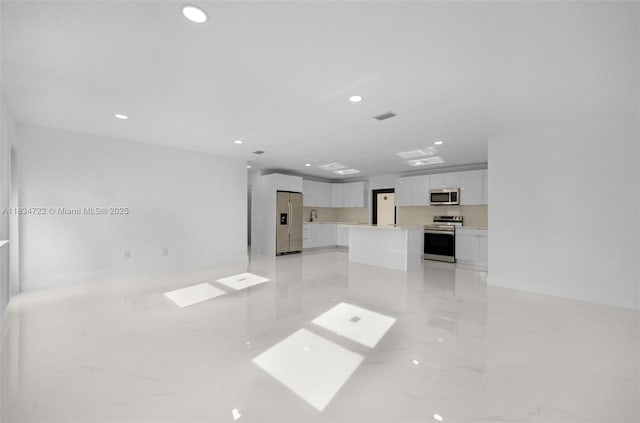 324 SW 16th Ter, Homestead, FL 33030 - unfurnished living room featuring light marble finish floors and recessed lighting