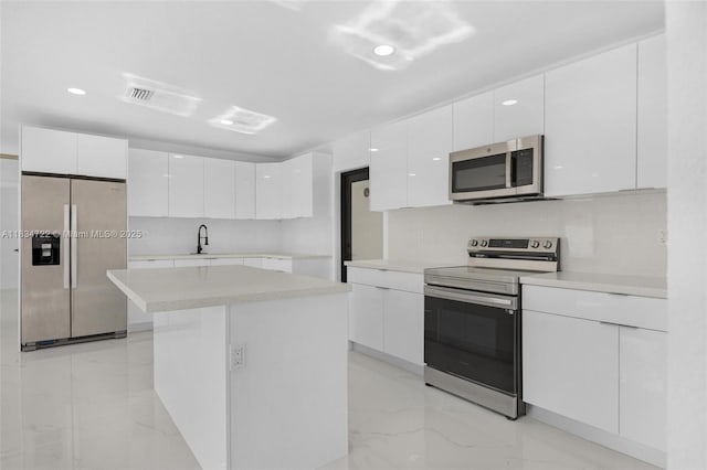 324 SW 16th Ter, Homestead, FL 33030 - kitchen featuring stainless steel appliances, modern cabinets, white cabinets, and recessed lighting