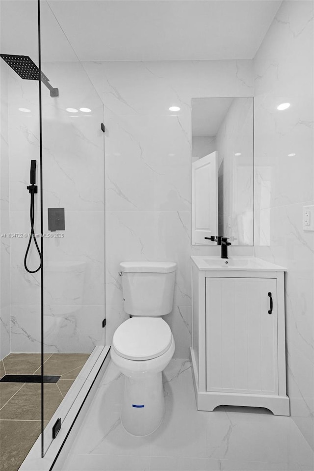 324 SW 16th Ter, Homestead, FL 33030 - bathroom featuring marble look tiles, a marble finish shower, vanity, and tile walls