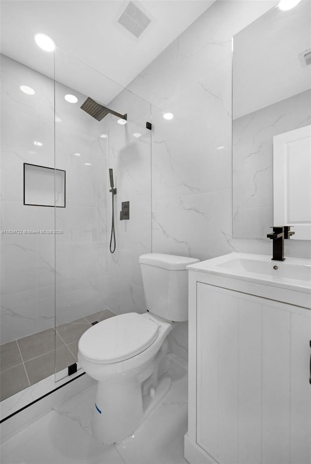 324 SW 16th Ter, Homestead, FL 33030 - full bathroom featuring vanity, marble tiled flooring, a marble finish shower, and tile walls