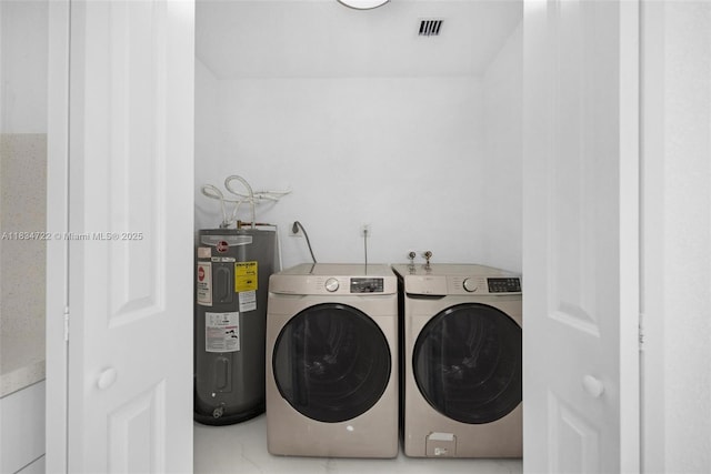 324 SW 16th Ter, Homestead, FL 33030 - laundry area featuring water heater and washing machine and clothes dryer
