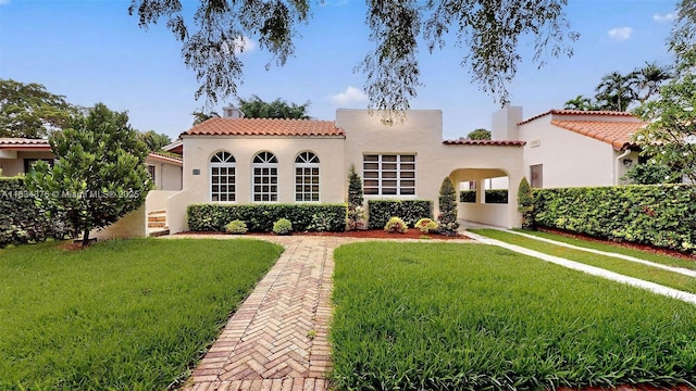 1111 Columbus Blvd, Coral Gables, FL 33134 - view of front of home with a tiled roof, a front lawn, stucco siding, and a chimney