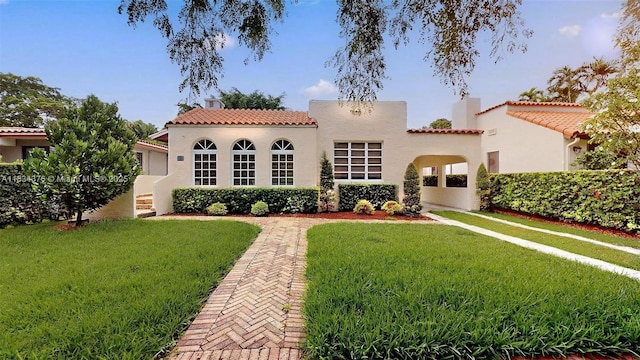 1111 Columbus Blvd, Coral Gables, FL 33134 - view of front of house with a tiled roof, a front lawn, stucco siding, and a chimney