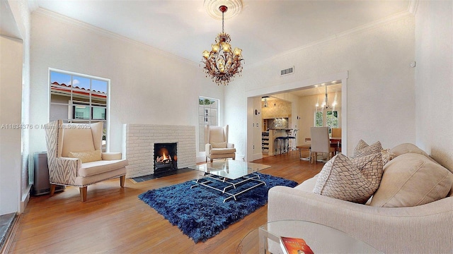 1111 Columbus Blvd, Coral Gables, FL 33134 - living room with a chandelier, ornamental molding, wood finished floors, and a brick fireplace