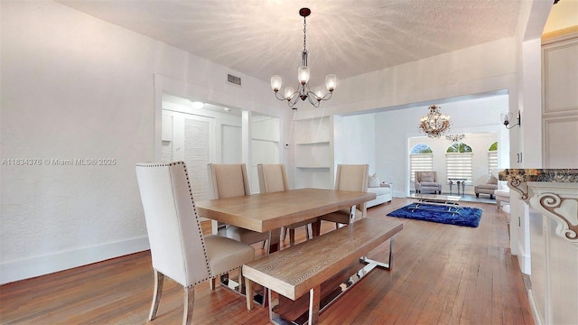 1111 Columbus Blvd, Coral Gables, FL 33134 - dining area with a chandelier, hardwood / wood-style floors, and built in features