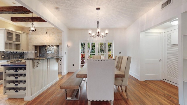 1111 Columbus Blvd, Coral Gables, FL 33134 - dining space featuring a chandelier, light wood-style floors, and a textured ceiling
