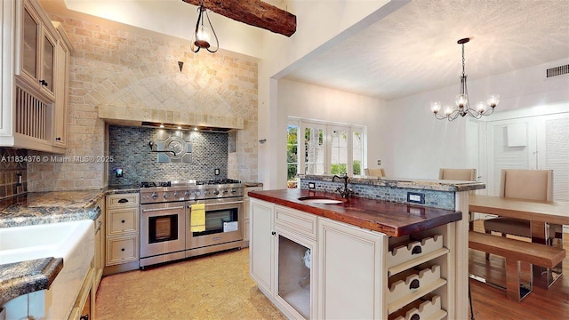 1111 Columbus Blvd, Coral Gables, FL 33134 - kitchen with double oven range, backsplash, butcher block countertops, and a chandelier