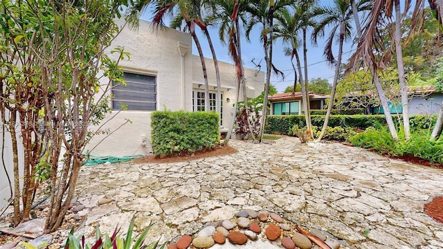 1111 Columbus Blvd, Coral Gables, FL 33134 - view of front of home with stucco siding and a patio area