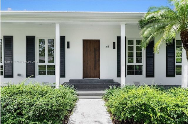45 NE 104th St, Miami Shores, FL 33138 - view of exterior entry featuring stucco siding and a porch