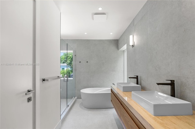 45 NE 104th St, Miami Shores, FL 33138 - full bath featuring a stall shower, a freestanding tub, double vanity, and tile patterned flooring