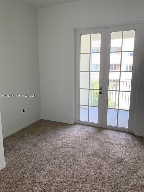 1209 Main St Unit 215, Jupiter, FL 33458 - carpeted spare room with french doors and baseboards