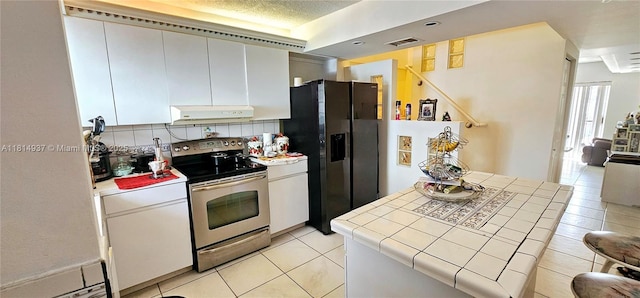 3494 E 4th Ave Unit 1207, Hialeah, FL 33013 - kitchen featuring stainless steel electric range, tile countertops, refrigerator with ice dispenser, light tile patterned floors, and range hood