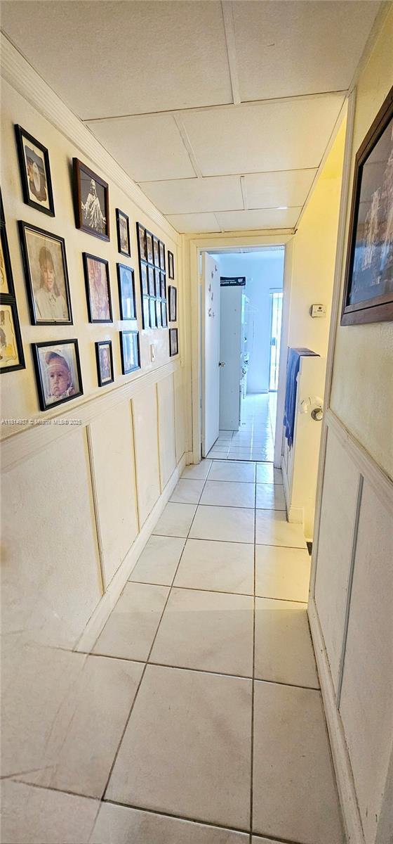 3494 E 4th Ave Unit 1207, Hialeah, FL 33013 - hallway with light tile patterned flooring