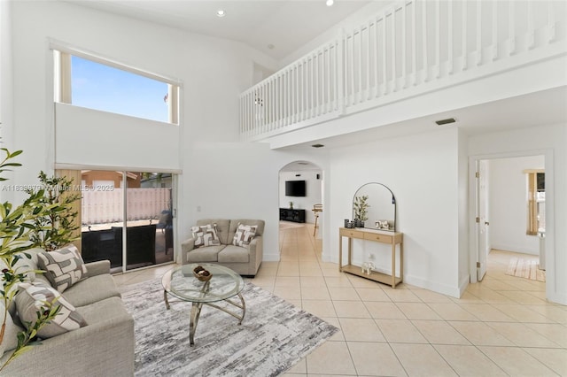 1894 SW 149th Ave, Miramar, FL 33027 - living room with arched walkways, a towering ceiling, light tile patterned floors, and recessed lighting