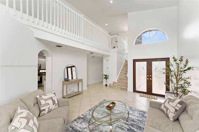 1894 SW 149th Ave, Miramar, FL 33027 - living area featuring a high ceiling, arched walkways, tile patterned flooring, stairway, and recessed lighting