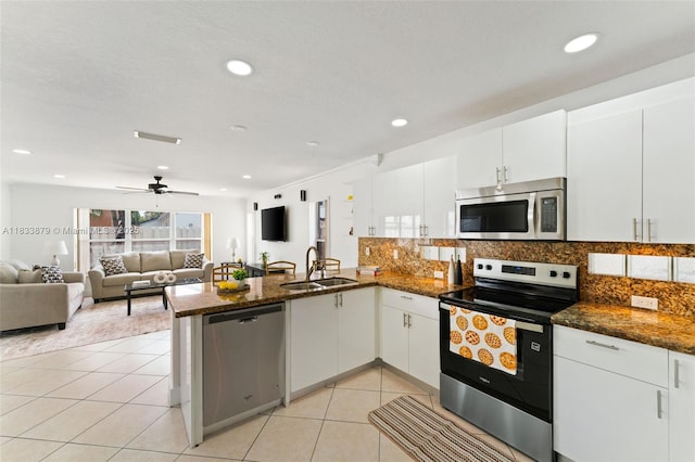 1894 SW 149th Ave, Miramar, FL 33027 - kitchen with appliances with stainless steel finishes, a peninsula, light tile patterned flooring, white cabinets, and recessed lighting
