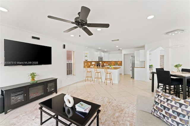 1894 SW 149th Ave, Miramar, FL 33027 - living area featuring light tile patterned flooring, recessed lighting, a ceiling fan, and arched walkways
