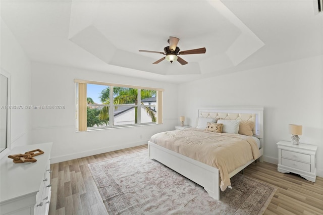 1894 SW 149th Ave, Miramar, FL 33027 - bedroom featuring a raised ceiling, light wood finished floors, and ceiling fan