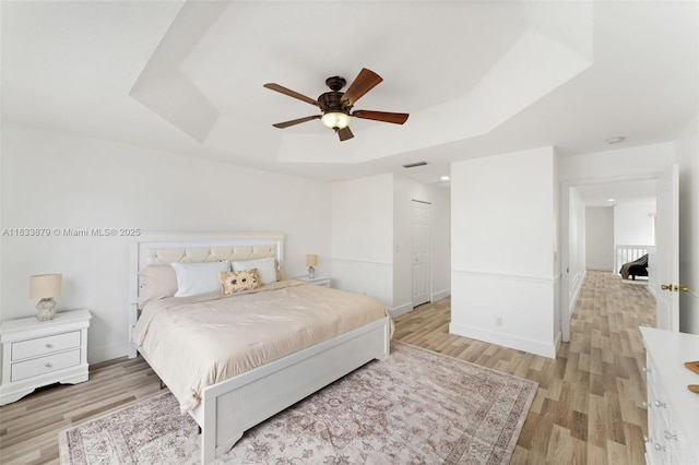 1894 SW 149th Ave, Miramar, FL 33027 - bedroom with a tray ceiling, light wood-style flooring, and a ceiling fan