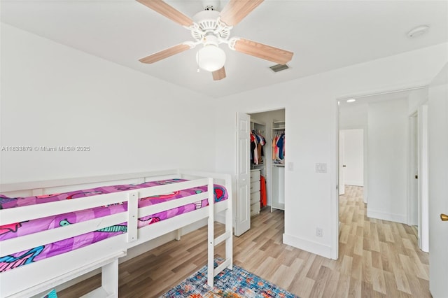 1894 SW 149th Ave, Miramar, FL 33027 - bedroom with wood finished floors, a walk in closet, ceiling fan, and a closet