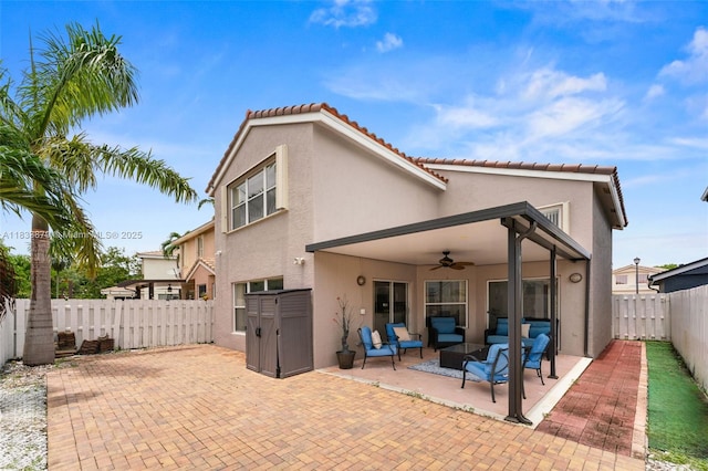 1894 SW 149th Ave, Miramar, FL 33027 - back of house featuring a patio area, ceiling fan, outdoor lounge area, stucco siding, and a fenced backyard