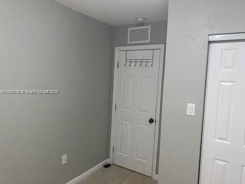 1770 NW 44th St, Miami, FL 33142 - unfurnished bedroom with light tile patterned flooring and baseboards
