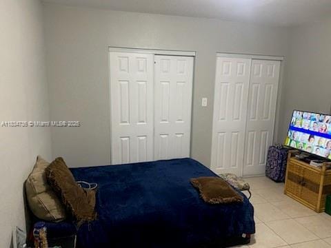 1770 NW 44th St, Miami, FL 33142 - bedroom with two closets and light tile patterned flooring