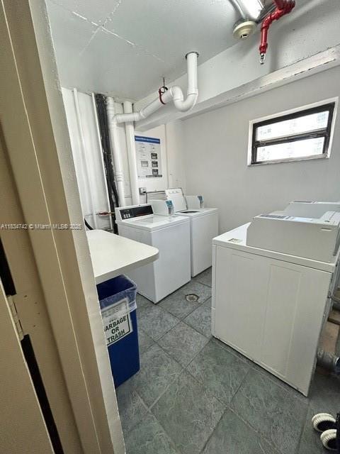 16909 N Bay Rd Unit 319, Sunny Isles Beach, FL 33160 - shared laundry with washing machine and clothes dryer and light tile patterned floors