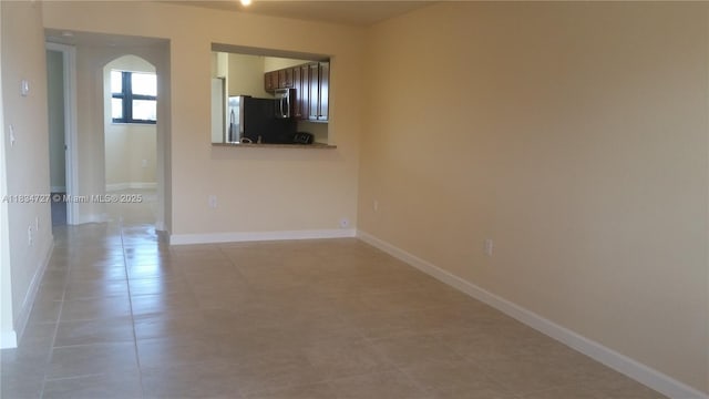 22441 SW 88th Pl Unit 204-5, Cutler Bay, FL 33190 - unfurnished room featuring light tile patterned floors and arched walkways