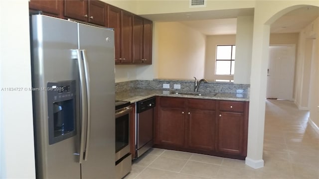 22441 SW 88th Pl Unit 204-5, Cutler Bay, FL 33190 - kitchen featuring stainless steel appliances, arched walkways, light stone countertops, and light tile patterned floors