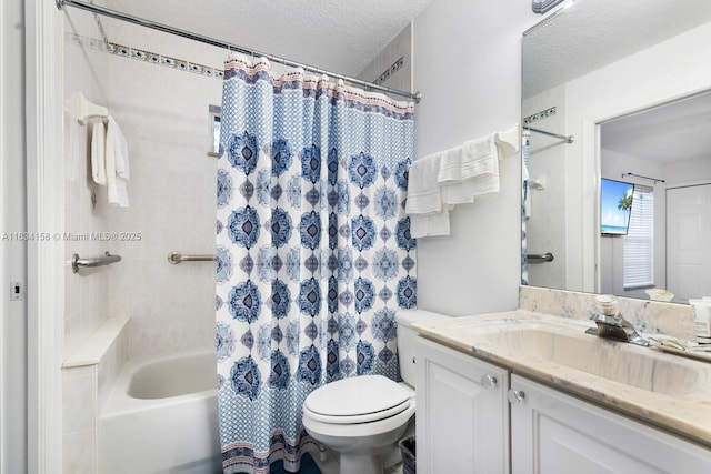 full bathroom featuring vanity, shower / tub combo with curtain, and a textured ceiling