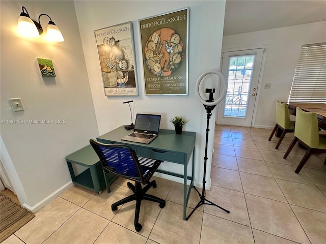 office space with baseboards and light tile patterned floors
