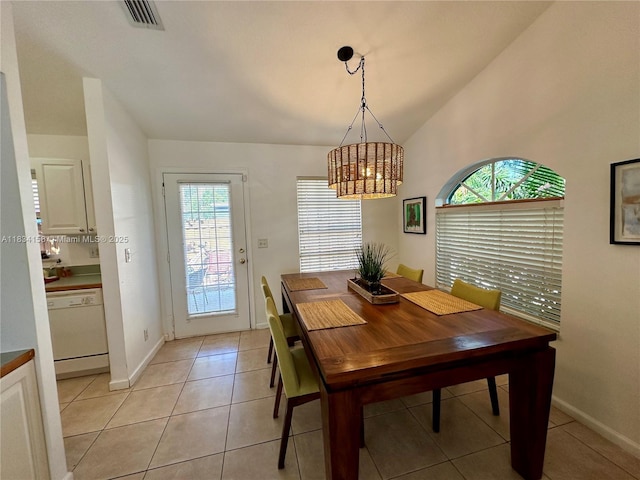 dining area featuring a chandelier, lofted ceiling, and light tile patterned floors