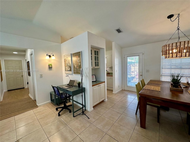 dining room featuring light tile patterned floors, lofted ceiling, and a desk