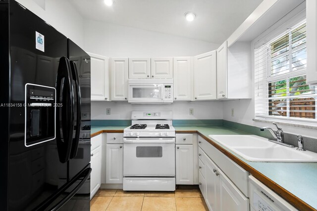 kitchen featuring white appliances, white cabinets, vaulted ceiling, light tile patterned flooring, and recessed lighting