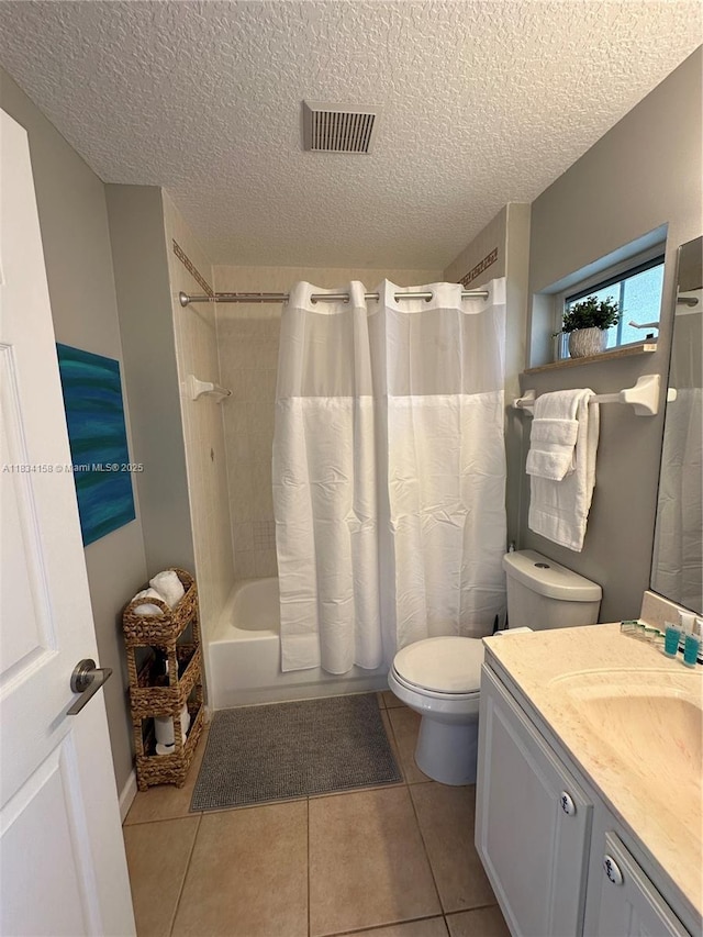 bathroom with vanity, shower / tub combo, a textured ceiling, and tile patterned floors