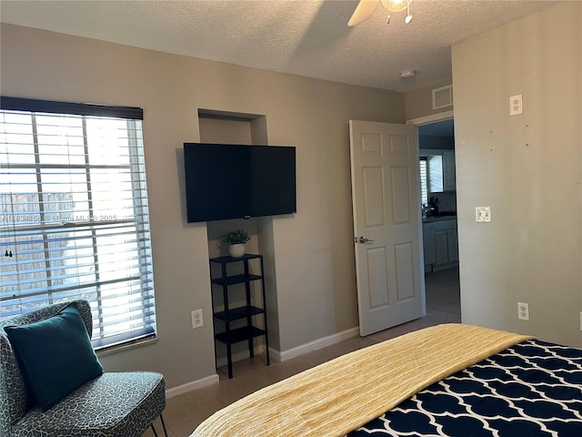 bedroom with tile patterned flooring, a textured ceiling, and a ceiling fan