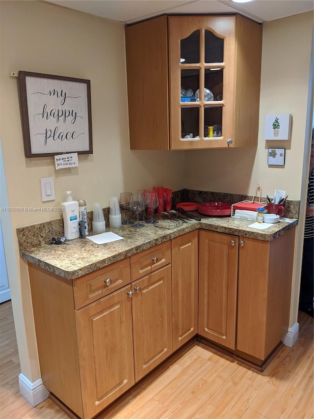 900 Saint Charles Pl Unit L6, Pembroke Pines, FL 33026 - kitchen with light wood finished floors, glass insert cabinets, and brown cabinets