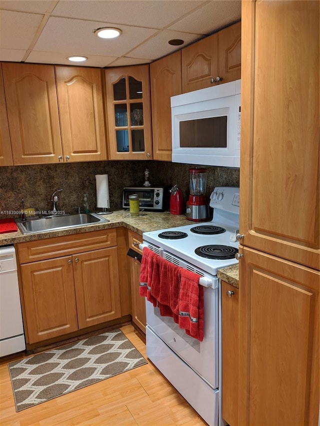 900 Saint Charles Pl Unit L6, Pembroke Pines, FL 33026 - kitchen with white appliances, decorative backsplash, glass insert cabinets, light wood-style flooring, and a drop ceiling