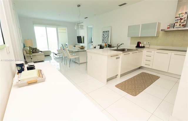 150 Sunny Isles Blvd Unit 1-Th403, Sunny Isles Beach, FL 33160 - kitchen with a peninsula, tasteful backsplash, hanging light fixtures, light tile patterned flooring, and black electric stovetop