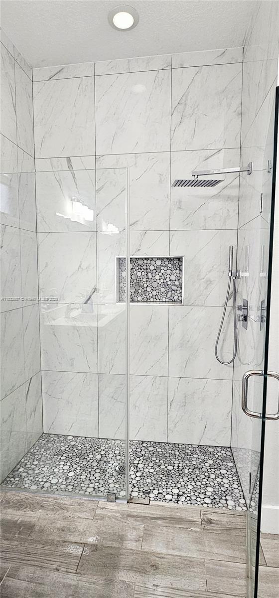 17186 N 84th Ct, Loxahatchee, FL 33470 - bathroom featuring a stall shower and wood finished floors