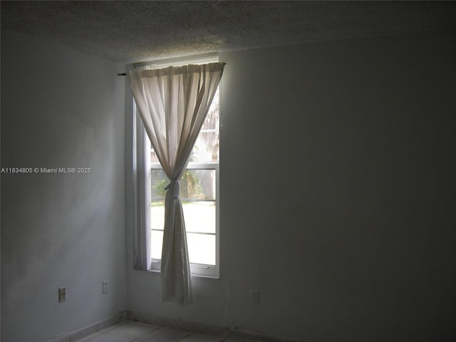 8841 W Flagler St Unit 103, Miami, FL 33174 - spare room featuring a textured ceiling and tile patterned flooring
