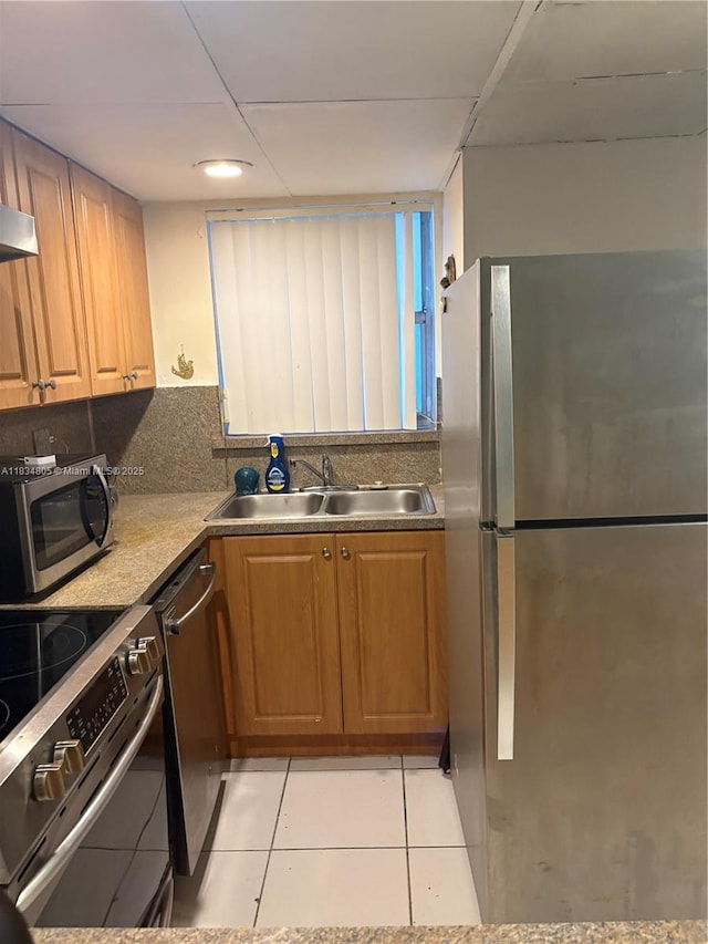 8841 W Flagler St Unit 103, Miami, FL 33174 - kitchen with stainless steel appliances, light tile patterned flooring, brown cabinetry, and backsplash