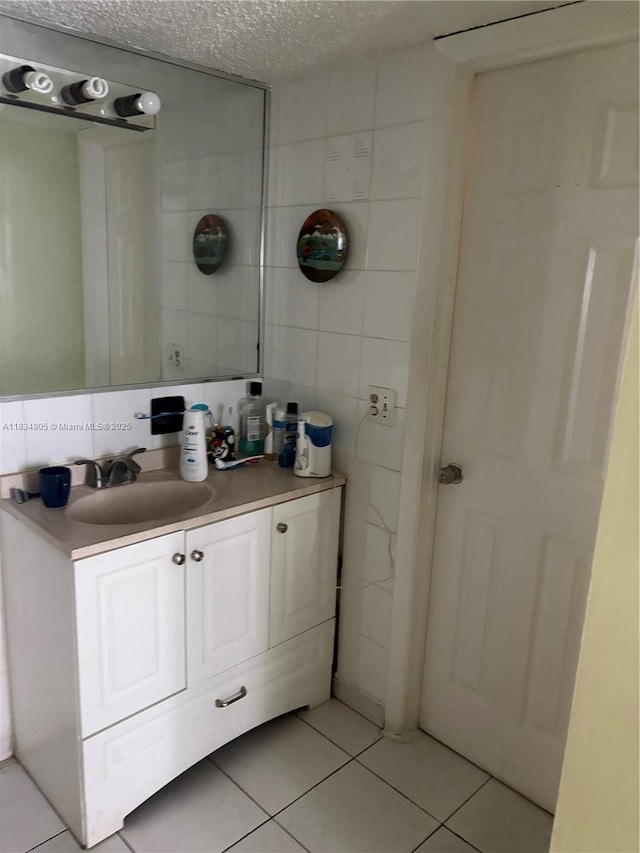 8841 W Flagler St Unit 103, Miami, FL 33174 - bathroom with tile walls, tile patterned floors, vanity, and a textured ceiling