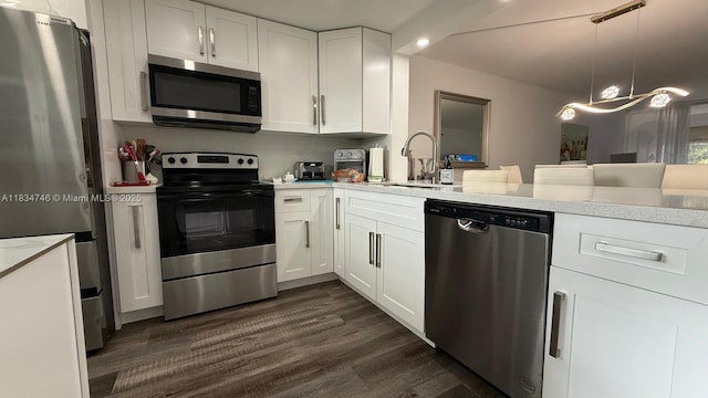 3910 Inverrary Blvd Unit 503-B, Lauderhill, FL 33319 - kitchen featuring appliances with stainless steel finishes, white cabinetry, dark wood finished floors, recessed lighting, and hanging light fixtures