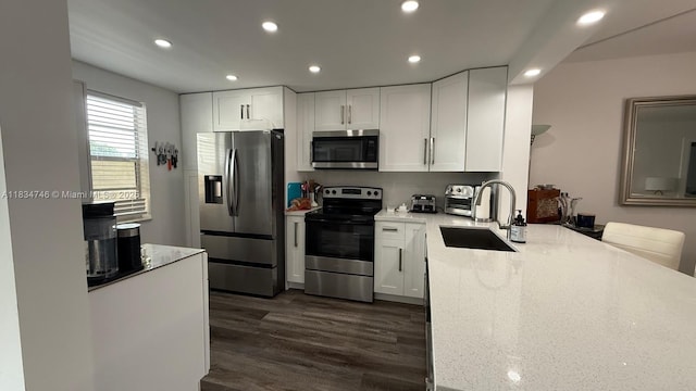 3910 Inverrary Blvd Unit 503-B, Lauderhill, FL 33319 - kitchen featuring stainless steel appliances, light stone countertops, recessed lighting, white cabinetry, and dark wood-type flooring