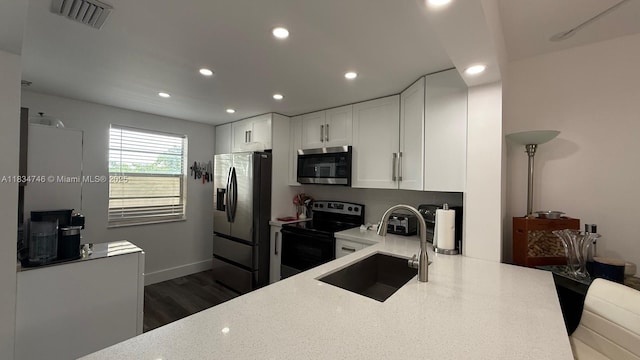 3910 Inverrary Blvd Unit 503-B, Lauderhill, FL 33319 - kitchen with stainless steel appliances, recessed lighting, white cabinets, and dark wood finished floors