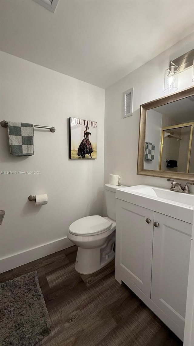 3910 Inverrary Blvd Unit 503-B, Lauderhill, FL 33319 - bathroom featuring vanity, an enclosed shower, and wood finished floors
