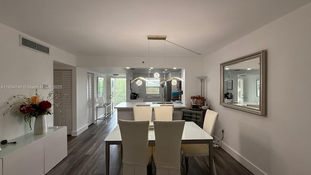 3910 Inverrary Blvd Unit 503-B, Lauderhill, FL 33319 - dining area featuring baseboards and dark wood-style flooring