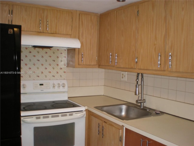 5855 Washington St Unit 92, Hollywood, FL 33023 - kitchen featuring white range with electric stovetop, under cabinet range hood, freestanding refrigerator, and light countertops